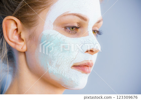 Girl with white green mud mask on face Girl with white green mud mask on face 123309676