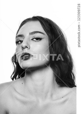 Beautiful brunette woman with wavy long hair and make-up close-up studio portrait Beautiful brunette woman with wavy long hair and make-up close-up studio portrait 123309728