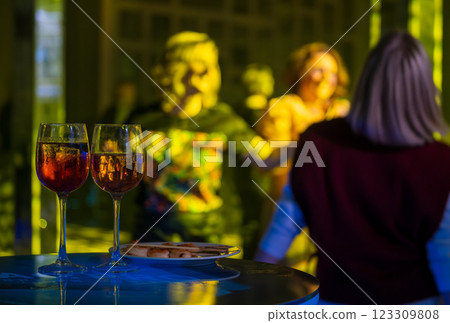 Two glasses of wine on a table at a lively evening party 123309808