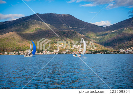 Two sailing boats with students and instructors training in the Kotor Bay, Montenegro, highlighting teamwork, adventure, and nautical education. Two sailing boats with students and instructors training in the Kotor Bay, Montenegro, highlighting teamwork, adventure, and nautical education. 123309894