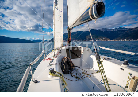 Sports yacht sailing in the Kotor Bay, Montenegro, representing adventure, freedom, and nautical exploration. Sports yacht sailing in the Kotor Bay, Montenegro, representing adventure, freedom, and nautical exploration. 123309904