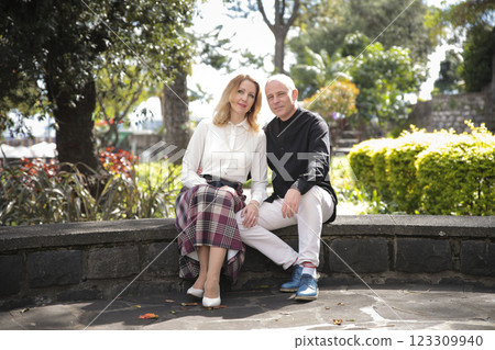 Couple enjoying romantic vacation in lush tropical garden Couple enjoying romantic vacation in lush tropical garden 123309940