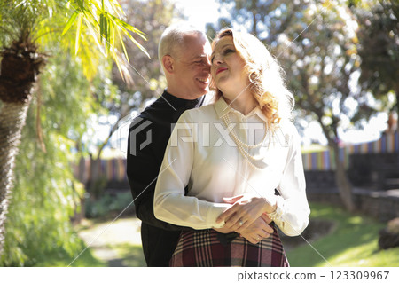 Happy couple embracing in lush tropical garden in madeira island, portugal Happy couple embracing in lush tropical garden in madeira island, portugal 123309967