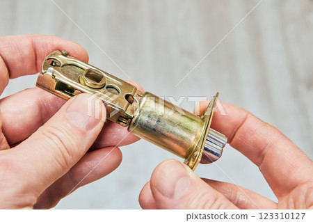 Latch bolt hardware, exhibits extendable bolt, metal housing, and fixing points, commonly used in interior door installations for privacy and security. 123310127