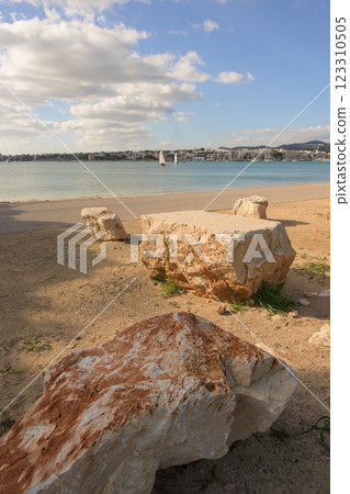 large rocks, calm waters and a city large rocks, calm waters and a city 123310505