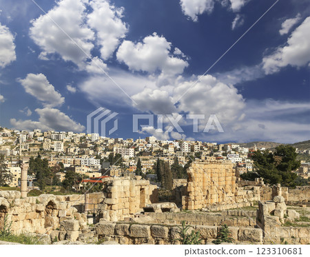 Roman ruins (against the background of a beautiful sky with clouds) in the Jordanian city of Jerash (Gerasa of Antiquity), capital and largest city of Jerash Governorate, Jordan 123310681
