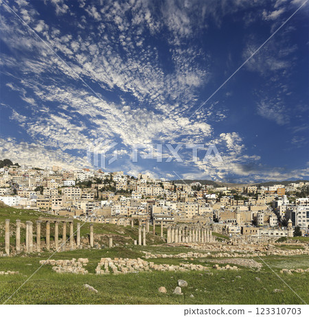 Roman ruins (against the background of a beautiful sky with clouds) in the Jordanian city of Jerash (Gerasa of Antiquity), capital and largest city of Jerash Governorate, Jordan 123310703