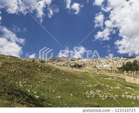 Roman ruins (against the background of a beautiful sky with clouds) in the Jordanian city of Jerash (Gerasa of Antiquity), capital and largest city of Jerash Governorate, Jordan Roman ruins (against the background of a beautiful sky with clouds) in the Jordanian city of Jerash (Gerasa of Antiquity), capital and largest city of Jerash Governorate, Jordan 123310725