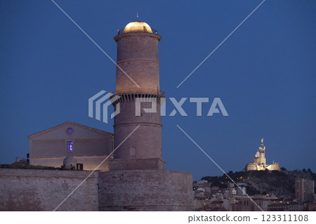 Tower of the lantern and Notre-Dame de la Garde Basilica in Marseille during the blue hour Tower of the lantern and Notre-Dame de la Garde Basilica in Marseille during the blue hour 123311108