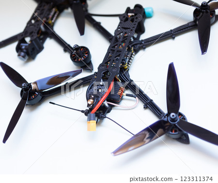 FPV drone in production on white background. 123311374