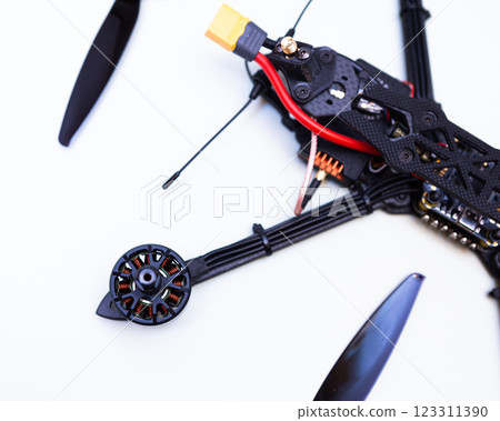 FPV drone in production on white background. FPV drone in production on white background. 123311390
