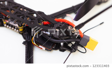 FPV drone in production on white background. FPV drone in production on white background. 123311403