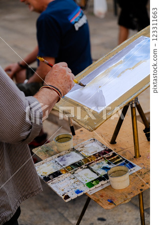 Street artist at work with watercolor Street artist at work with watercolor 123311663