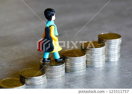 Small human figure climbs a staircase made of euro coins, symbolic of young persons path to success Small human figure climbs a staircase made of euro coins, symbolic of young persons path to success 123311757
