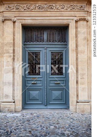 Wooden door and stone wall on a facade 123312519