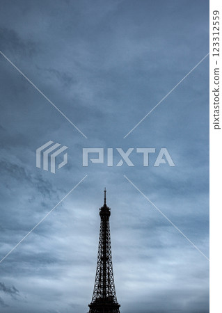 Famous Parisian monument and cloudy sky on background Famous Parisian monument and cloudy sky on background 123312559
