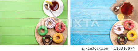 glazed donuts with a cup of tea on a green wooden background with copy space for your text. Top view glazed donuts with a cup of tea on a green wooden background with copy space for your text. Top view 123313674