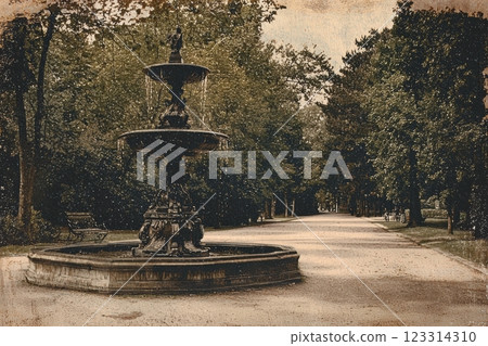 Antique fountain in tranquil park setting surrounded by lush greenery in vintage postcard style 123314310