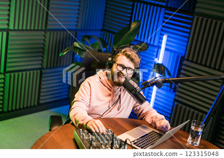 Handsome man radio DJ hosting a radio show, entertainment and communication concept Handsome man radio DJ hosting a radio show, entertainment and communication concept 123315048