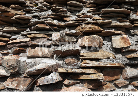Texture of brown weathered stone wall 123315573