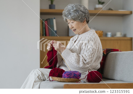 A woman in her 80s knitting A woman in her 80s knitting 123315591