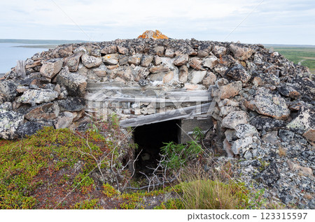 Old destroyed stone pillbox in tundra 123315597