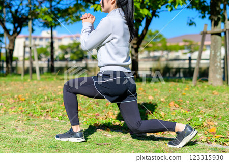 Young woman training her lower body in a green space: lunges, split squats, self-improvement, diet Young woman training her lower body in a green space: lunges, split squats, self-improvement, diet 123315930