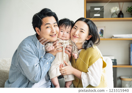 Portrait of a family holding a baby Portrait of a family holding a baby 123315940