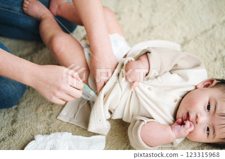 A newborn baby having his/her diaper changed 123315968