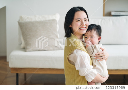 Portrait of a woman holding a newborn baby 123315969