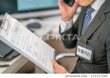 A male employee who does telephone sales on behalf of another person A male employee who does telephone sales on behalf of another person 123317260