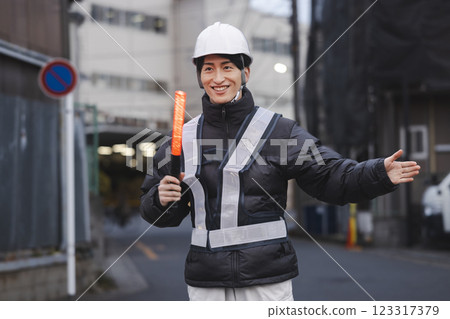 A young man directing traffic 123317379