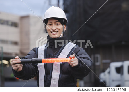 A young man directing traffic A young man directing traffic 123317396