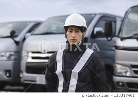 Worker standing in front of the truck 123317401