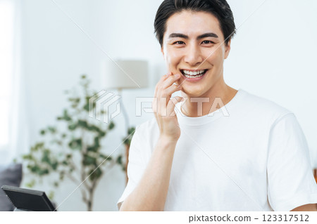 Young man smiling and showing white teeth Young man smiling and showing white teeth 123317512