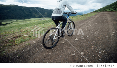 Riding mountain bike on grassland mountain top 123318647