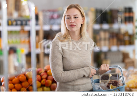 Young woman choosing food in grocery store Young woman choosing food in grocery store 123318708