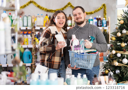 Couple shopping for gifts in supermarket before celebrating Christmas Couple shopping for gifts in supermarket before celebrating Christmas 123318716