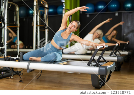 Woman doing back exercises in Pilates class 123318771