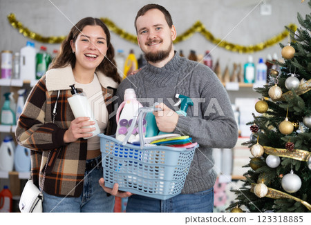 Couple man and woman choosing household chemicals in decorated store 123318885