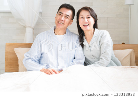 A couple waking up and having a conversation in bed A couple waking up and having a conversation in bed 123318958