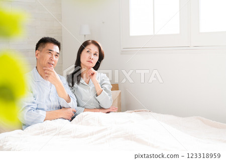 A couple waking up and having a conversation in bed A couple waking up and having a conversation in bed 123318959