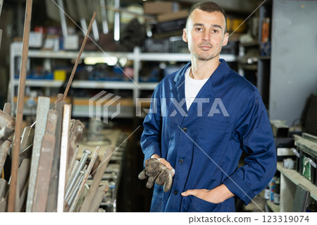 Portrait of professional male worker during work with steel in workshop Portrait of professional male worker during work with steel in workshop 123319074