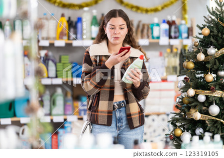 Young woman scanning qr code for dishwashing Young woman scanning qr code for dishwashing 123319105
