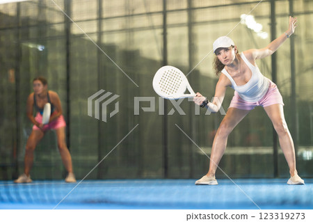 Young and adult women playing doubles tennis 123319273