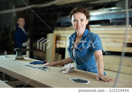 Adult woman posing with oak plank 123319450