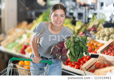 Young girl purchaser buying beetroots in grocery store 123319461