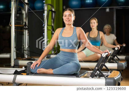 Portrait of a woman on a reformer Portrait of a woman on a reformer 123319600