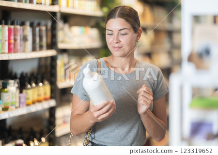 Girl choosing organic cosmetics in eco-friendly produce store Girl choosing organic cosmetics in eco-friendly produce store 123319652