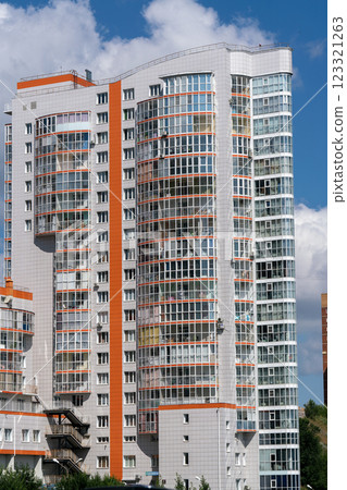 Facade of multi-storey buildings with windows and balconies. 123321263